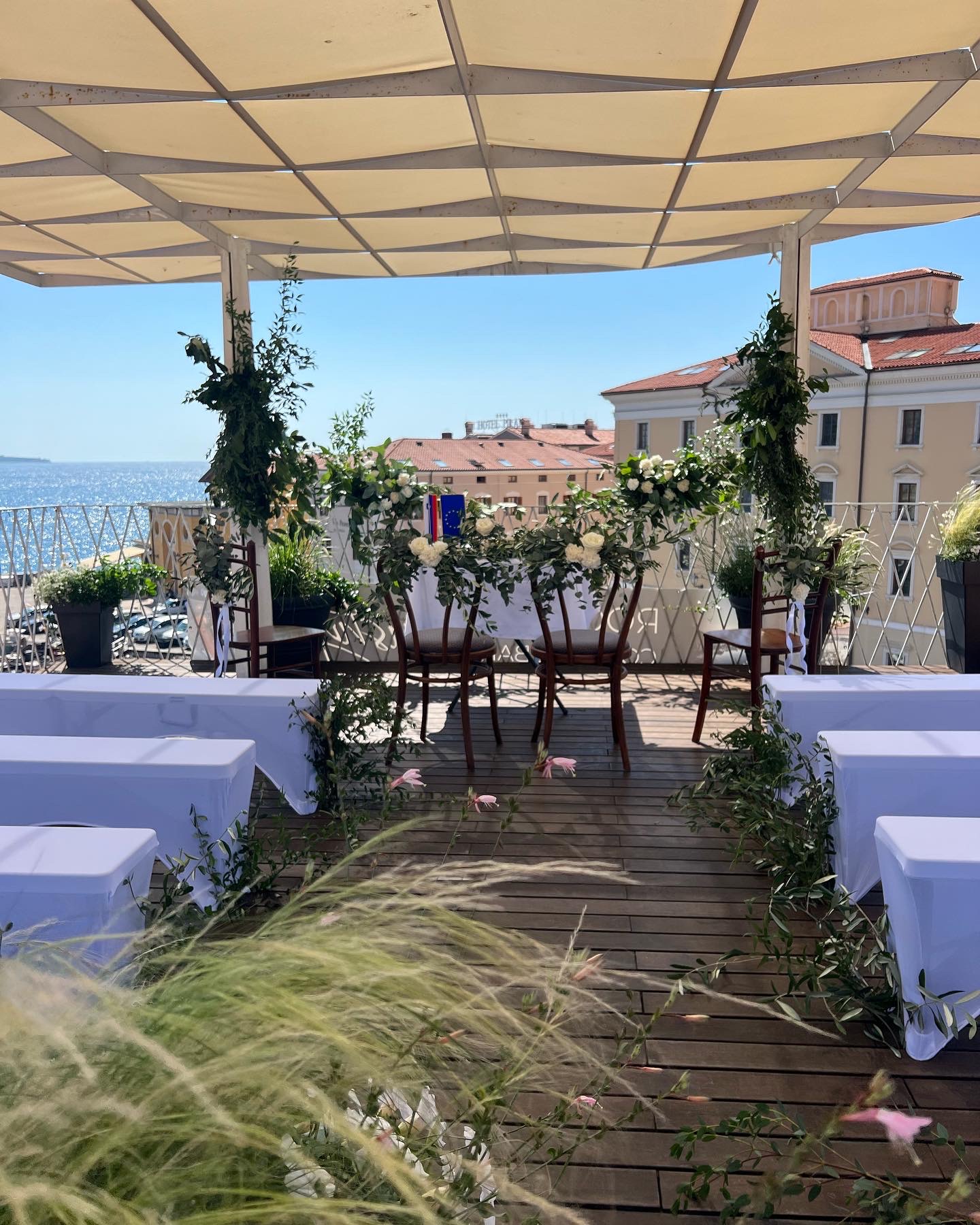 A wedding ceremony set up on the Tartini Rooftop terrace, overlooking the Adriatic and the old town of Piran